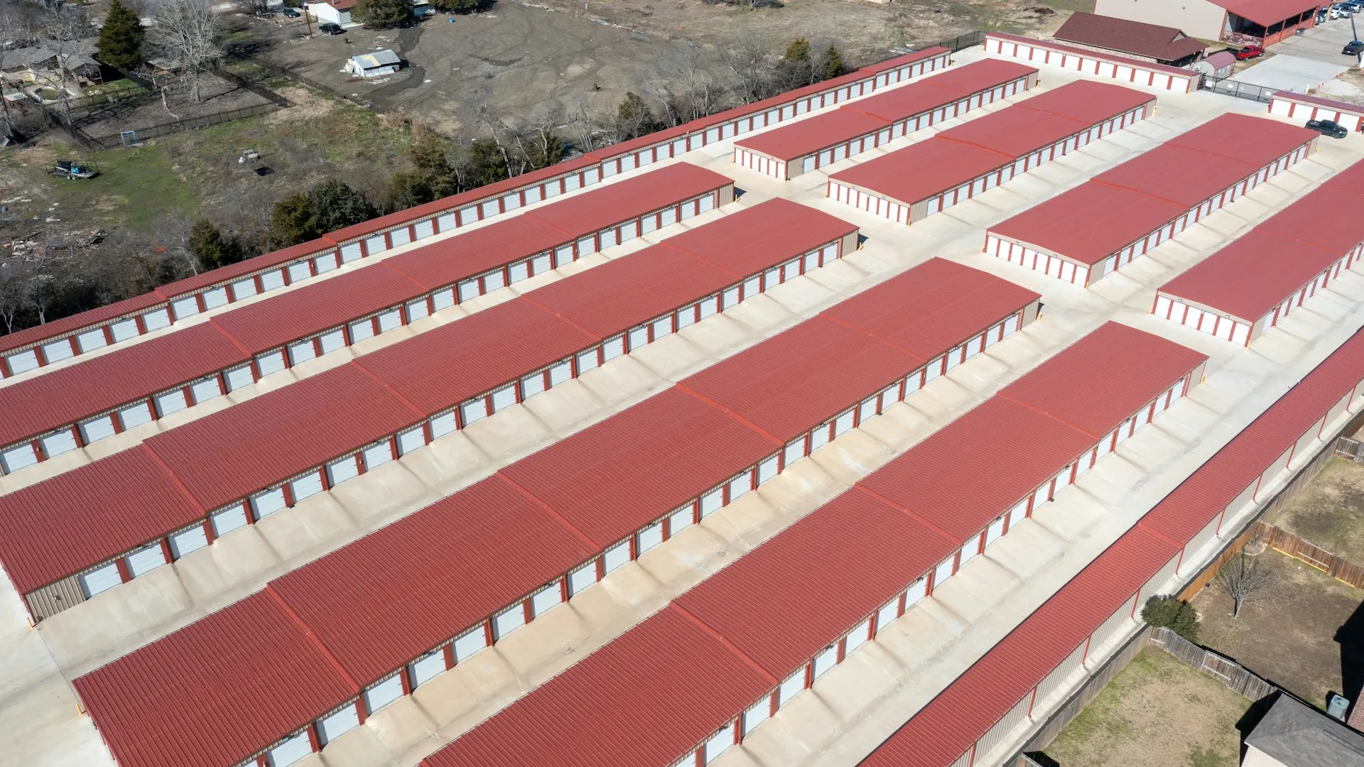 Aerial view of a multi-building self-storage facility with red-roof drive-up units